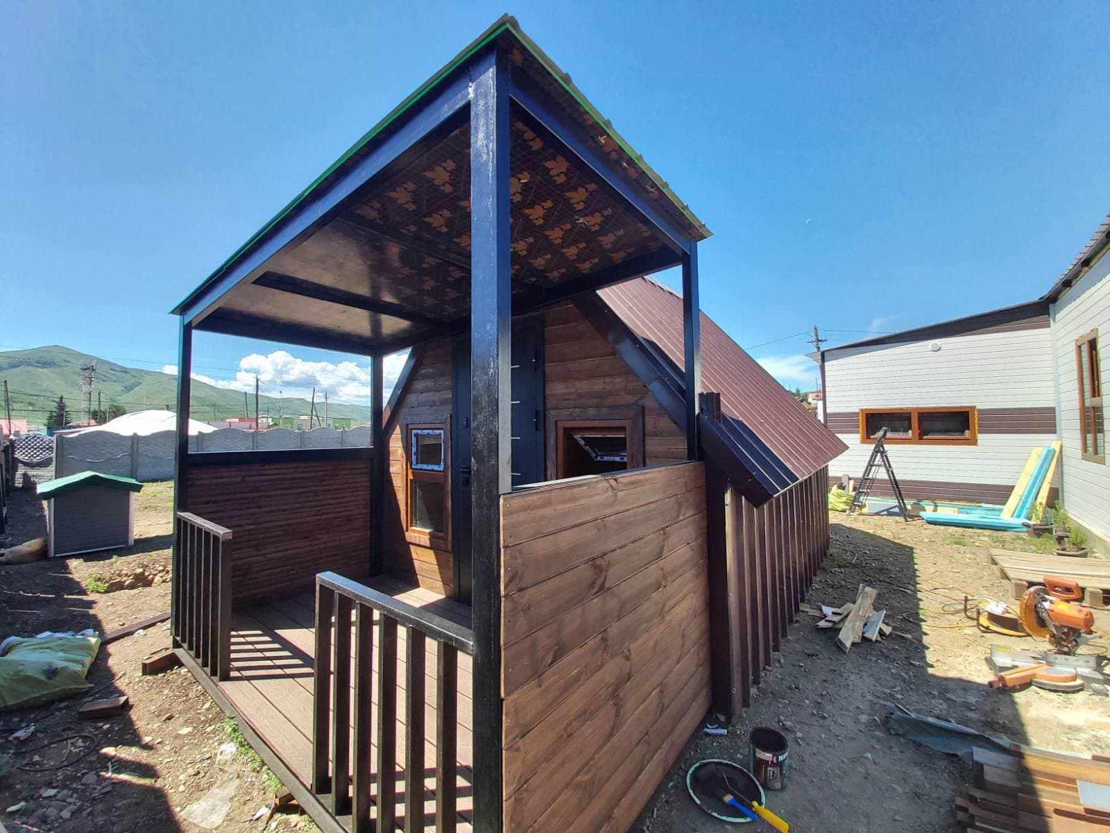 Timber cabin with covered porch built by Paul